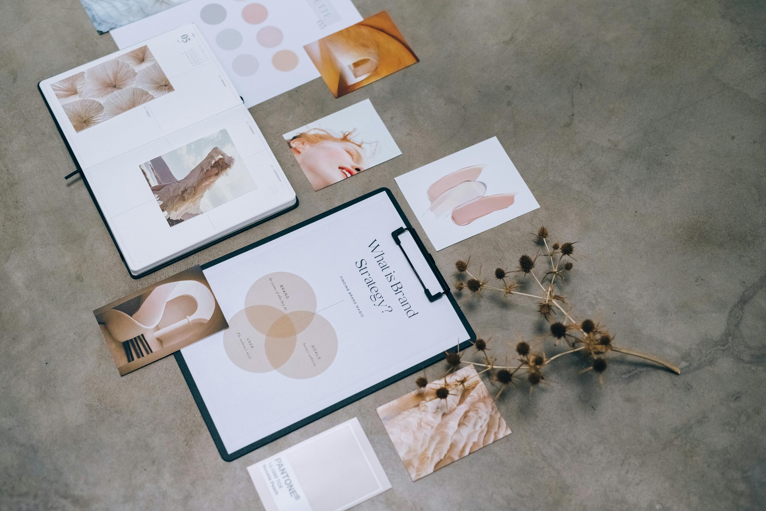 A modern flat lay of branding strategy documents and design elements on a desk.